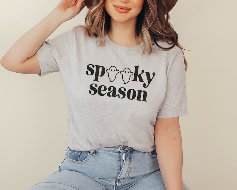 May include: A gray t-shirt with the text "spooky season" in black lettering and three small ghost illustrations.