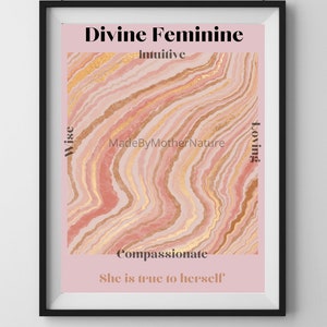 May include: Framed art print featuring a pink and gold abstract design with the words "Divine Feminine" and other related words. The print is in a black frame and is hanging on a white wall.