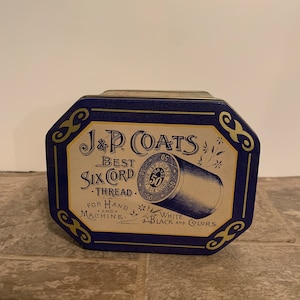 May include: A blue and gold tin box with the text "J&P Coats Best Six Cord Thread" and "For Hand and Machine. White, Black and Colors." The box features a spool of thread with the text "J&P Coats Six Cord 50" on it.