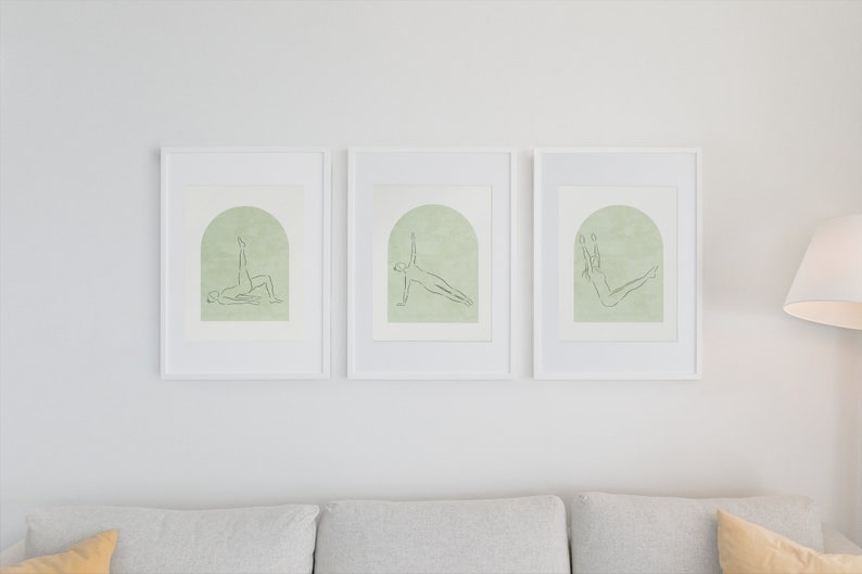 May include: Three framed illustrations of people in different yoga poses. Each illustration is in black and white line art on a light green background with a white arch shape.