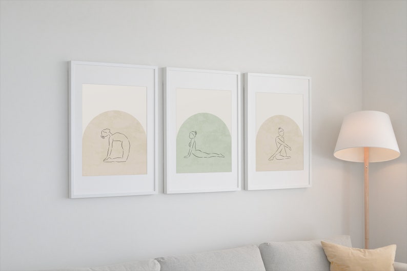 May include: Three framed prints with minimalist line drawings of people in yoga poses. Each print features a different pose and a muted background color.
