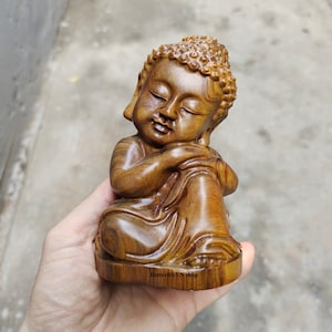 Small wooden statue of Gautama Buddha