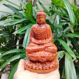 Wooden Gautama Buddha Sitting On a Lotus flower, Shakyamuni Buddha statue, The statue sitting with eyes half-closed