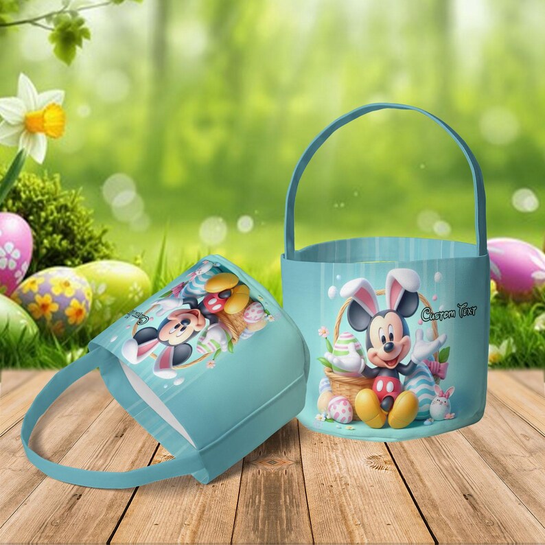 May include: Two light blue Easter baskets with handles. One basket is lying on its side. Both baskets feature Mickey Mouse dressed as the Easter Bunny, surrounded by Easter eggs. The text "Custom Text" is visible on one basket.