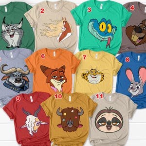 May include: A collection of eleven short-sleeved t-shirts in various colors, each featuring a cartoon animal graphic. The shirts are in shades of green, tan, blue, orange, and yellow, with designs including a snake, a rabbit, and a sloth.