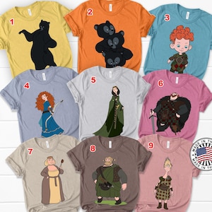 May include: A collection of nine graphic t-shirts in various colors, each featuring a cartoon character design. The shirts are numbered 1 through 9, with designs including bears, a redhead boy, a woman with a bow, and other characters.