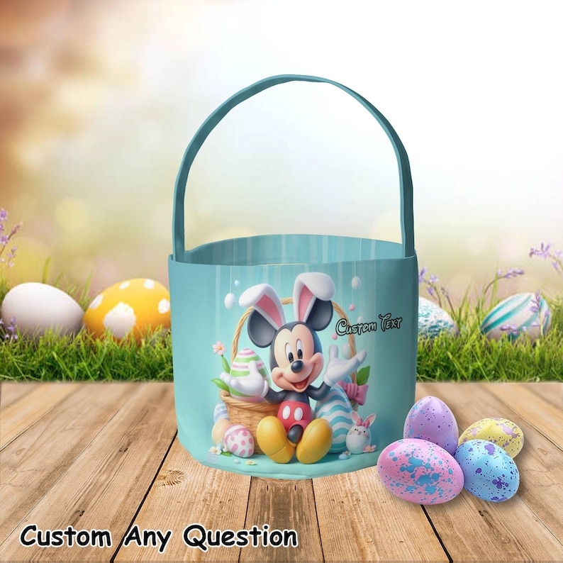 May include: A light blue Easter basket featuring Mickey Mouse in bunny ears, surrounded by Easter eggs. The basket has a handle and the words "Custom Text" are visible. The words "Custom Any Question" are at the bottom.