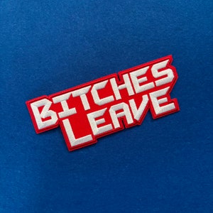 May include: Red and white embroidered patch with the text "BITCHES LEAVE" in a bold, blocky font.