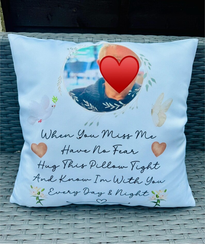 May include: A light blue throw pillow with a floral design and a photo of a person in the centre. The pillow has the text "When You Miss Me Have No Fear Hug This Pillow Tight And Know I'm With You Every Day & Night" printed on it.