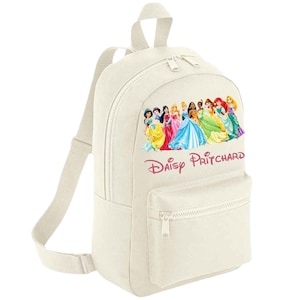 May include: Cream-coloured backpack with a colourful graphic of Disney princesses. The backpack has a front pocket, adjustable straps, and the name "Daisy Pritchard" printed in pink script.