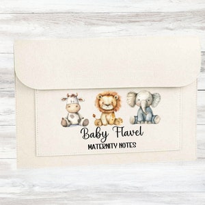 May include: A white fabric folder with a pocket for storing papers. The folder has a design of a cow, lion, and elephant with the text "Baby Flavel Maternity Notes".
