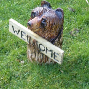 Chainsaw Carved Bear in a log with welcome sign