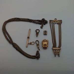 Lot of assorted watch fobs slides and chain