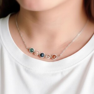 Model wearing a dainty Sagittarius birthstone necklace. Elegant layered jewelry style, unique handmade spiritual gift for her, ships from USA.