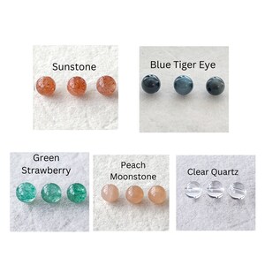 Detailed view of natural gemstones: Sunstone, Blue Tiger Eye, Green Strawberry Quartz, Peach Moonstone, and Clear Quartz beads for custom jewelry.
