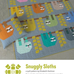 May include: A light blue quilt and pillow set featuring colorful sloths hanging from branches. The sloths are in shades of pink, orange, yellow, green, and blue. The quilt and pillow have a leaf pattern.