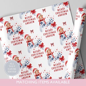 May include: White wrapping paper with a repeating pattern of a Christmas elf on a video game controller, red bows, and the text "MERRY CHRISTMAS ANDREW". The text "ALL TEXT CAN BE EDITED" is also visible.