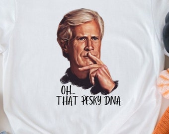 May include: White t-shirt with a graphic of a man with a mustache and the text "OH... THAT PESKY DNA".