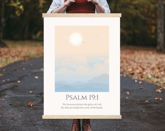May include: A printable wall art print with a minimalist design featuring a sunrise over a mountain range. The print includes the text "PSALM 19:1" and the verse "The heavens declare the glory of God, the skies proclaim the work of His hands."