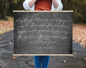 May include: A black chalkboard sign with white text that reads "May the Lord bless you and keep you; may the Lord make His face shine on you and be gracious to you; may the Lord turn His face toward you and give you peace. Numbers 6:24-26".