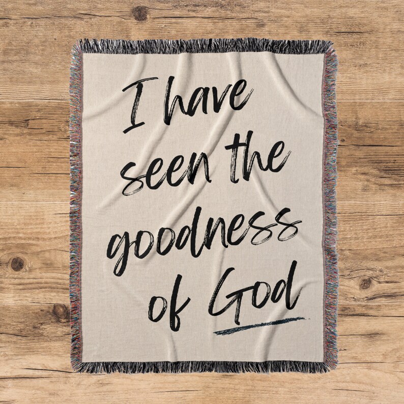 May include: A woven throw blanket with the text "I have seen the goodness of God" in black script.