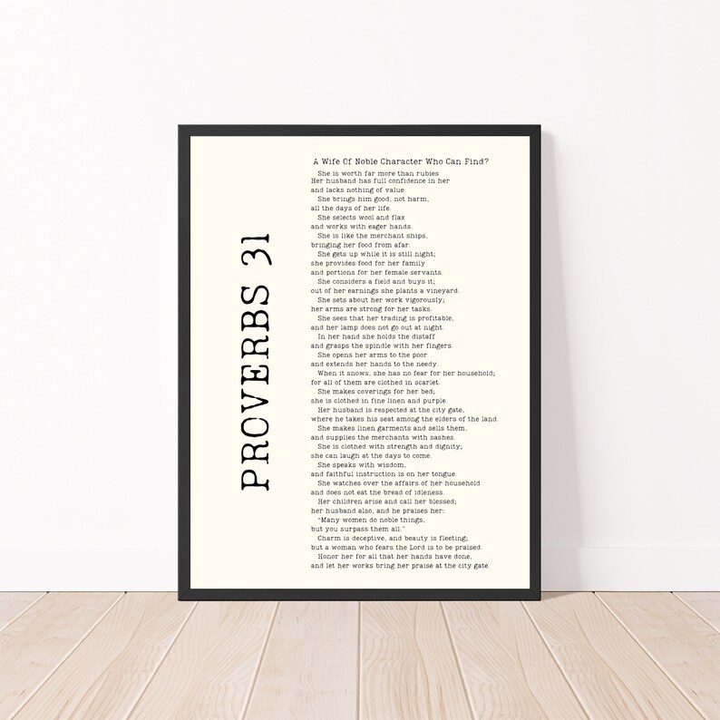 May include: A black and white framed print of Proverbs 31, a biblical passage about a virtuous woman. The text is in a traditional font and is centered on the page.