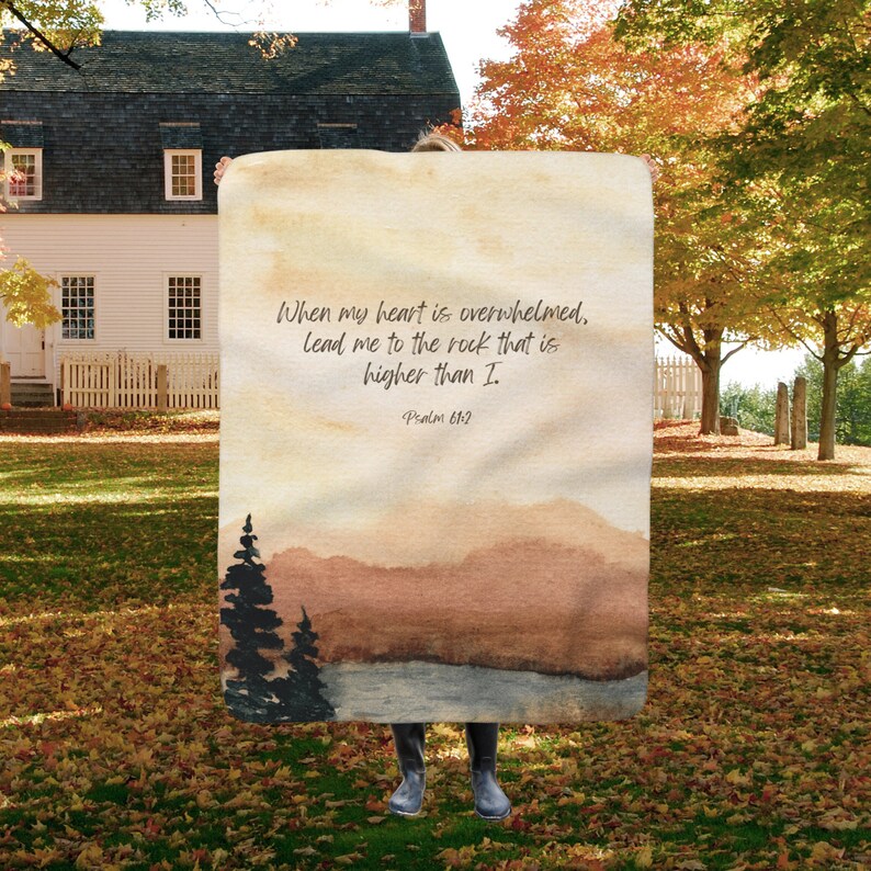 May include: A watercolour painting of a mountain landscape with a quote from Psalm 61:2, "When my heart is overwhelmed, lead me to the rock that is higher than I."