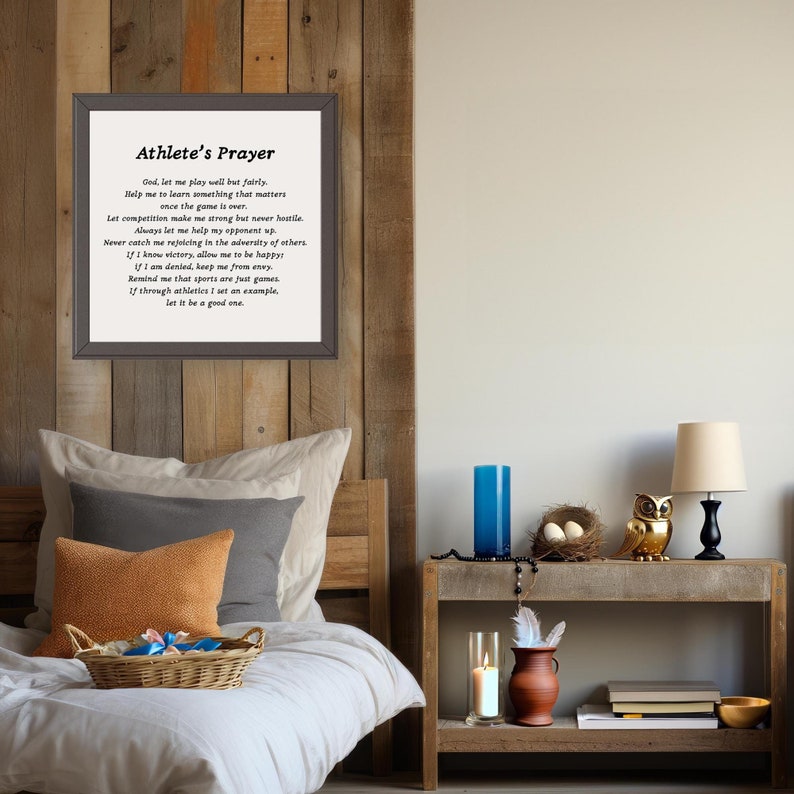 May include: A framed print with a black background and white text. The text is a poem titled "Athlete's Prayer" and includes the following lines: "God, let me play well but fairly. Help me to learn something that matters once the game is over."