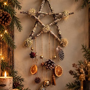 May include: A five-pointed star wall hanging constructed from natural twigs and decorated with light-coloured lichen. Hanging from the star are jute strings featuring dried orange slices, a pinecone, cinnamon sticks, a dried rose, and gold bells.