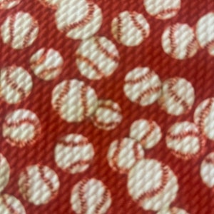 May include: Red fabric with a repeating pattern of white baseballs.