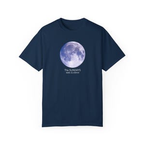 May include: A navy blue t-shirt with a full moon graphic and the text "The Sundays static & silence".