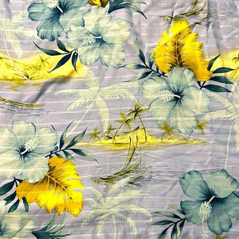 May include: A tropical floral fabric featuring large blue and white hibiscus flowers, yellow leaves, and palm trees. The background is a light gray with horizontal stripes, creating a beachy, Hawaiian-inspired design.