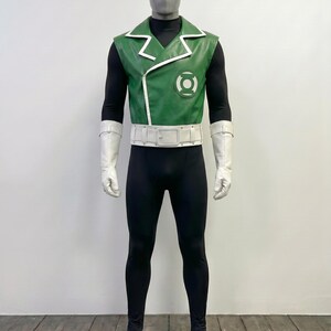 May include: A Green Lantern costume featuring a sleeveless green jacket with white trim and a circular logo on the chest. The outfit includes a black long-sleeved base layer, black leggings, a wide white belt with a buckle, and white gauntlet gloves.