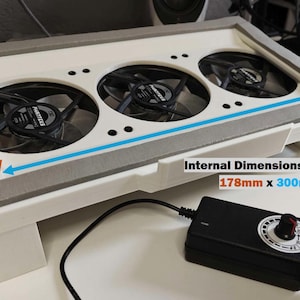 May include: White plastic box with three black fans and a gray foam lining. The internal dimensions of the foam are 178mm x 300mm.