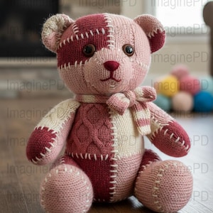 May include: Handmade patchwork teddy bear in shades of pink and burgundy. The bear features a knitted design with visible stitching, a striped scarf, and button eyes. A charming, handcrafted plush toy.