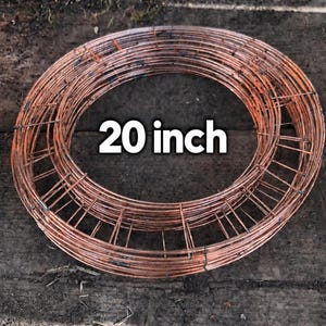 May include: A circular copper-coloured wire wreath frame with multiple concentric rings and cross-wire supports. The frame features the text 20 inch printed in white across the centre, indicating its diameter measurement in the imperial system.