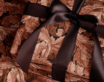 May include: A brown gift box with a dark brown satin ribbon tied in a bow. The box is wrapped in paper with a floral pattern.