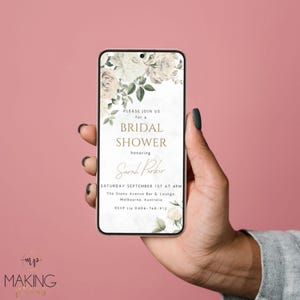 May include: A smartphone displays a bridal shower invitation. The invitation features floral accents and the text "PLEASE JOIN US for a BRIDAL SHOWER honoring Sarah Parker." The event details include the date, time, and location in Melbourne, Australia.