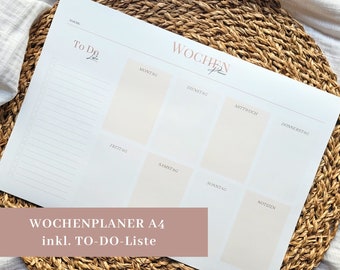 May include: A white weekly planner with a to-do list on the left side and a daily planner on the right side. The planner is labeled "Wochenplaner A4 inkl. TO-DO-Liste".