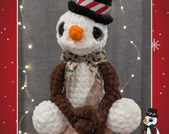 May include: A crocheted snowman wearing a black top hat with red and white stripes, a carrot nose, and a patterned bow tie. The snowman has brown arms and white pom-pom hands. The image includes the text "Meltin John" and "PDF Crochet Pattern".
