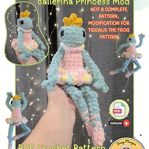 May include: A crocheted frog doll in a ballerina outfit. The frog is light blue with a pink tutu and a yellow crown. The image includes the text "Tiddalik the Frog" and "PDF Crochet Pattern".