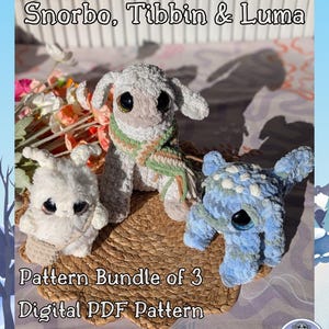 May include: Three handmade crochet plush toys: Snorbo, Tibbin, and Luma. The toys are in white, gray, and blue, with large, expressive eyes. The image includes text that reads "Pattern Bundle of 3 Digital PDF Pattern Download."