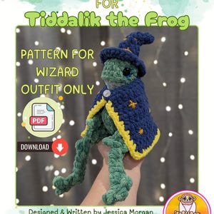 May include: A crochet pattern for a wizard hat and cloak for a frog named Tiddalik. The frog is wearing a blue hat with yellow stars and a matching cloak. The pattern is available for download.