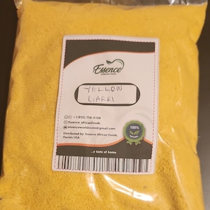 May include: A resealable plastic bag filled with yellow garri, a West African staple food. The bag has a label that reads "Essence African Foods" and "Yellow Garri". The label also includes contact information and a 100% natural logo.