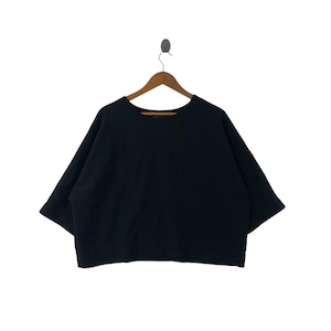 May include: A black, short-sleeved top with a wide, boxy silhouette. The top is hanging on a wooden hanger against a white background. The neckline is a simple scoop. The sleeves are wide and end at the elbow.