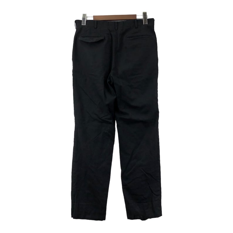 May include: Black dress pants hanging on a wooden hanger. The pants have a straight leg design and a single back pocket. The fabric appears to be a solid, dark color, suitable for formal or business attire.