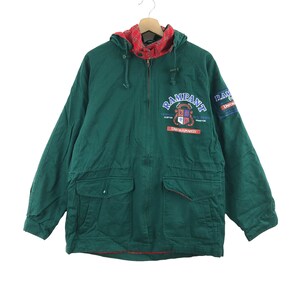 May include: A green hooded jacket with a red and black plaid lining. The jacket has a zipper closure and two large pockets on the front. The jacket has the word "Rampant" embroidered on the front with a crest and the words "Unfortunately" and "Uncontrollably" printed below.