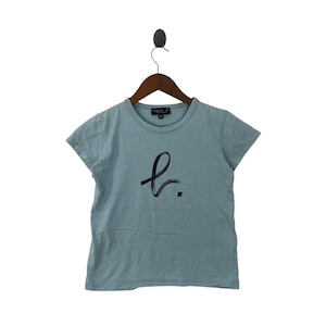 May include: A light blue t-shirt with a black stylized letter "L" graphic on the front. The shirt has short sleeves and a crew neck.