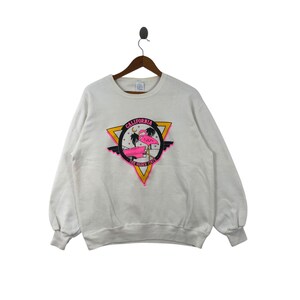 May include: White sweatshirt with a pink flamingo graphic and the text "California The Golden State" in a black triangle.