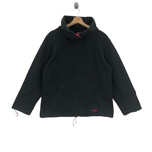 May include: Black hooded jacket with a red drawstring and a small red logo on the bottom.